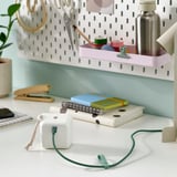 A workspace with a usb-c cable and desk organizer.