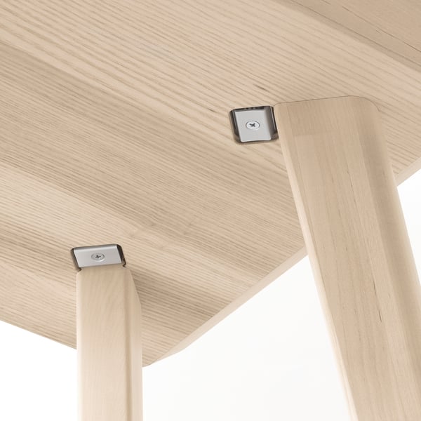 Wooden table detail: durable ash veneer top, sturdy birch legs, metal screws ensure stability.
