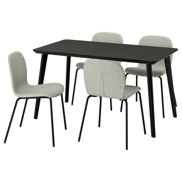 A modern black dining table with four light grey upholstered chairs, featuring sleek lines and a sturdy design.