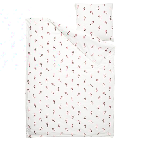 White holiday bedding set with red candy cane pattern, made from soft cotton.