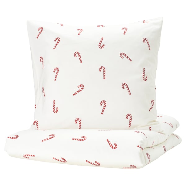 A white duvet set with red candy cane prints, made of soft cotton, perfect for a cozy and festive bedroom decor.