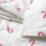 White duvet cover set with red candy cane print, featuring a zipper closure. Made of soft, warm cotton flannel.