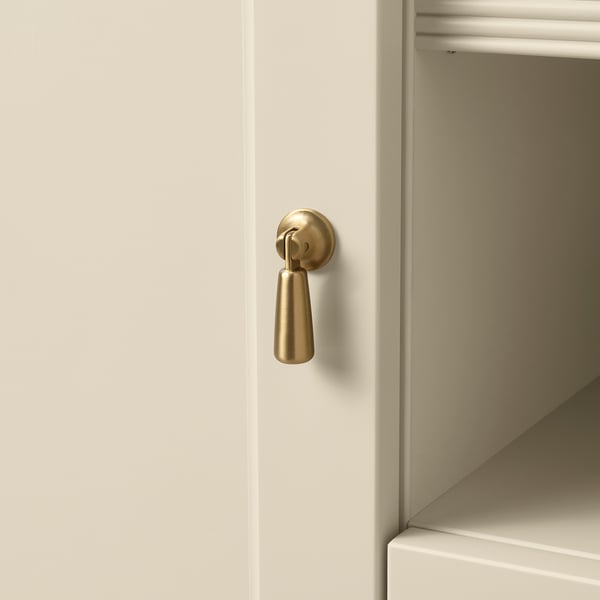 Modern white cabinet with sleek, polished gold handle, showcasing quality design and materials.