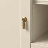 Modern white cabinet with sleek, polished gold handle, showcasing quality design and materials.