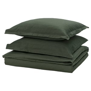 A set of dark green bedding including a duvet cover and two pillowcases made from 100% cotton, featuring a textured waffle weave design.