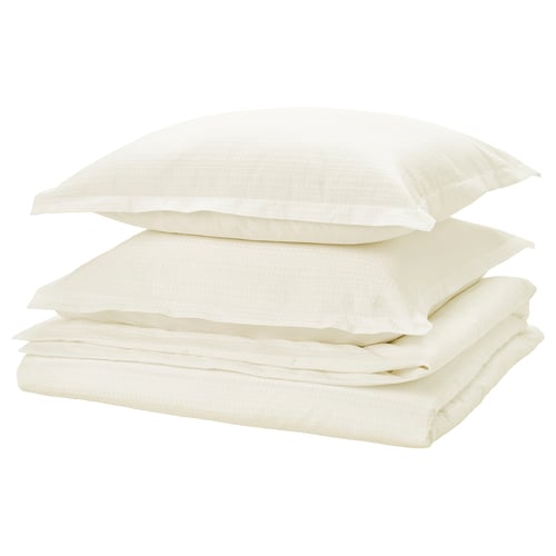 Folded white bed linen set with waffle texture, neatly stacked, light and soft.