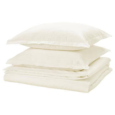 Folded white bed linen set with waffle texture, neatly stacked, light and soft.