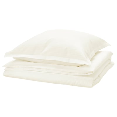 Neat stack of white LUKTVICKER cotton duvets. Soft waffle weave design, neatly folded.