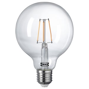 Ikea LUNNOM light bulb, globe-shaped, smoke-colored glass with spiral filament, warm light.