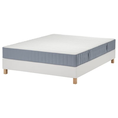 White LYNGÖR bed with grey mattress on wooden legs.