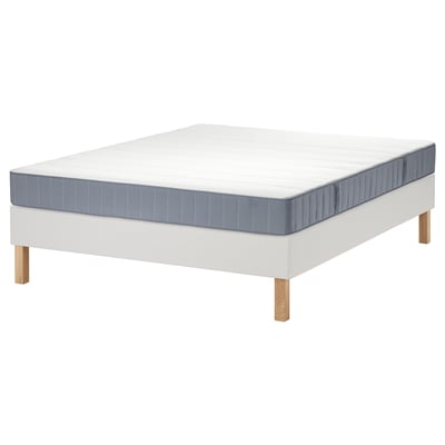 White LYNGÖR bed with gray mattress, wooden legs, flat frame, soft top, pocket springs.