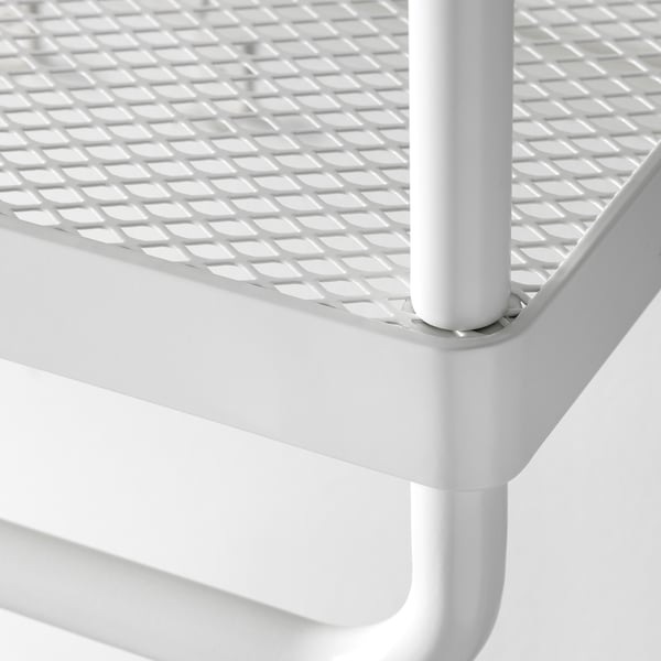 Close-up of white MACKAPÄR shelf, showcasing sturdy metal grid and robust coating.