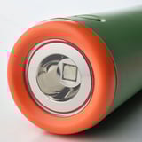 Cylindrical flashlight with bright led, shiny metal reflector, and vibrant orange-green body.