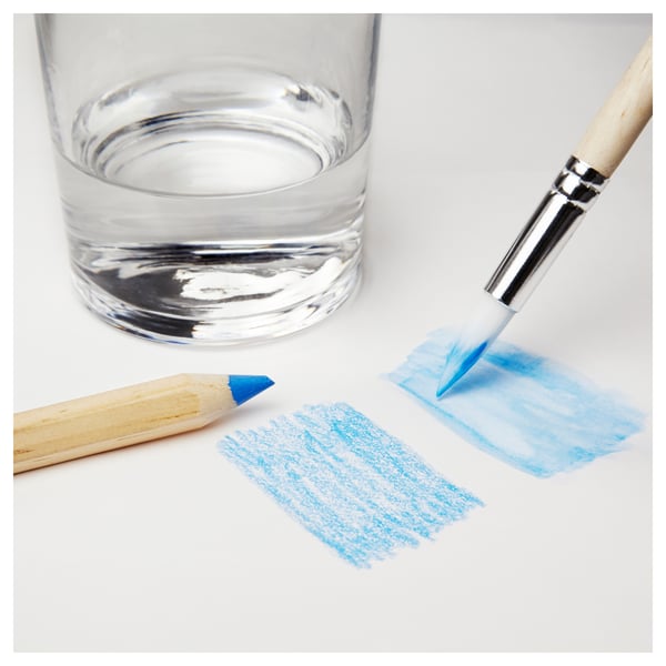 Kids art tools: water glass, brush with paint, on white.
