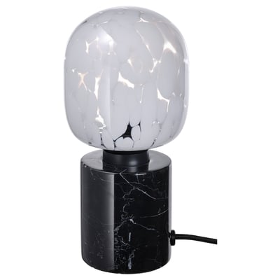 Modern lamp with black marble base, white glass bulb, spherical shape.