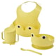 Yellow baby feeding set: bib, cup, bowl, spoon. Playful, functional design.