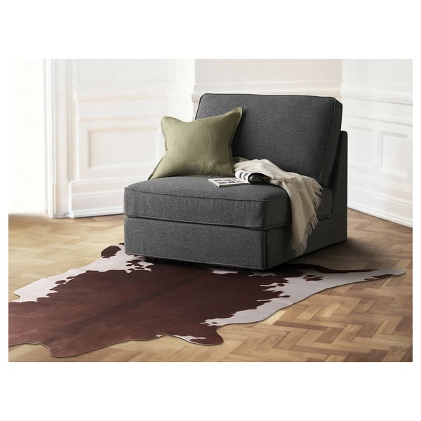 Versatile MAXTAXA rug, cowhide print, dark brown on cream, recycled polyester, l-shaped, wall-hangable.