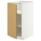 A white METOD kitchen cabinet with a light oak door, featuring a minimalist design and adjustable shelves.