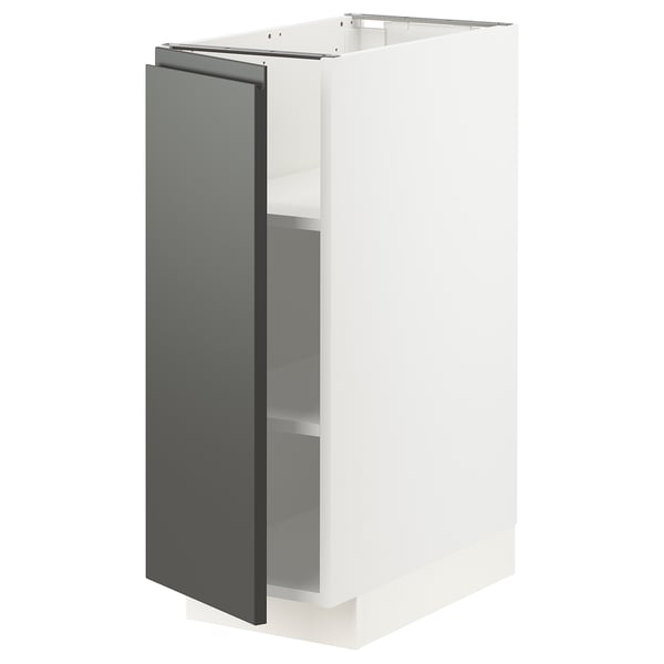 A white METOD kitchen unit with a dark grey door and adjustable shelves. Modern design, two-toned look.