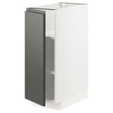 A white METOD kitchen unit with a dark grey door and adjustable shelves. Modern design, two-toned look.