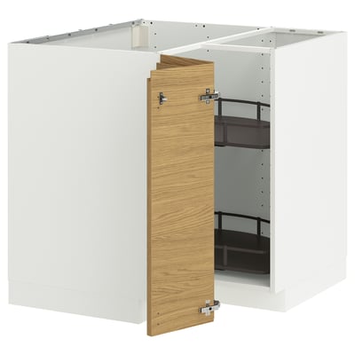 A white METOD kitchen cabinet with a light oak door partially open, revealing adjustable black shelves inside.