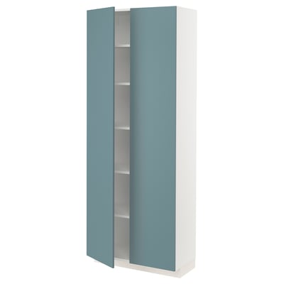 A white, tall METOD cabinet with blue doors and adjustable shelves.