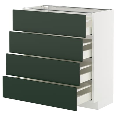 A white and dark green drawer unit from the METOD kitchen system. It four deep green pull-out drawers. The design is modern with sleek lines.