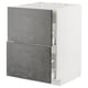 The METOD kitchen unit a white frame and dark grey concrete effect drawers. Modern and sleek design is perfect for urban kitchen aesthetics.