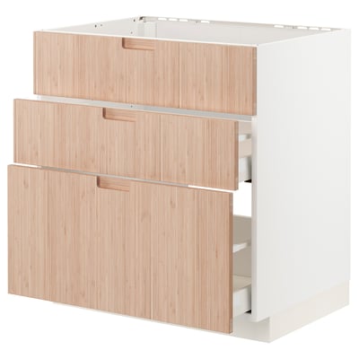 An ikea METOD kitchen cabinet with three light bamboo drawers. It a modern, minimalist design with sleek handles.