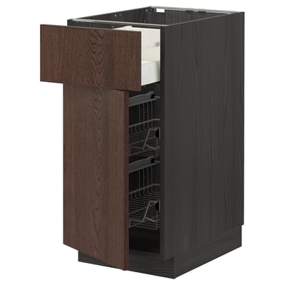 A dark brown kitchen cabinet with wooden texture, featuring one open drawer revealing wire racks inside.
