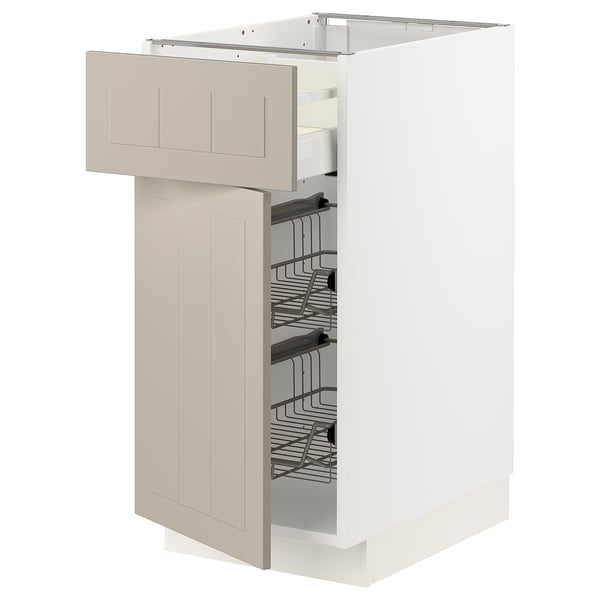 White METOD kitchen unit with beige drawer and racks.