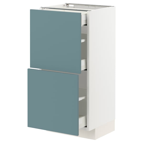 Modern kitchen cabinet in white with turquoise drawers.