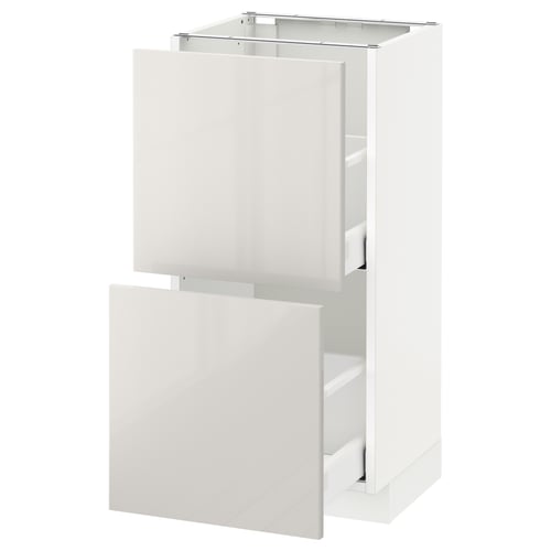 White, modern, high-gloss kitchen cabinet with two open drawers, sleek and minimalist design.