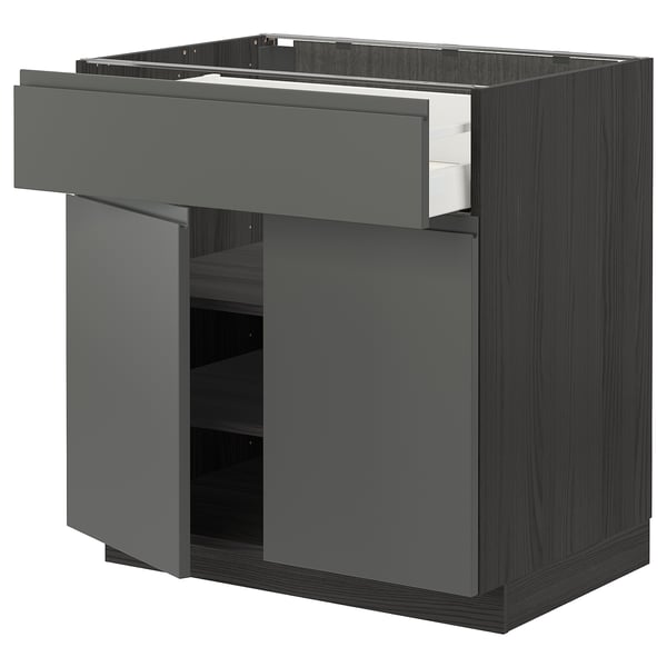 Modern kitchen cabinet in dark grey with sleek handle-less design, featuring a drawer and shelving unit.