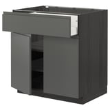 Modern kitchen cabinet in dark grey with sleek handle-less design, featuring a drawer and shelving unit.
