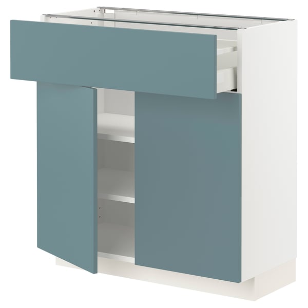 Turquoise white METOD kitchen cabinet with smooth drawers and shelves.