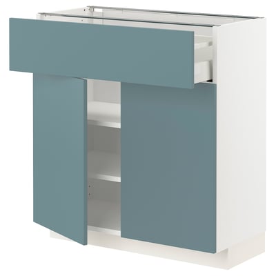 Turquoise white METOD kitchen cabinet with smooth drawers and shelves.