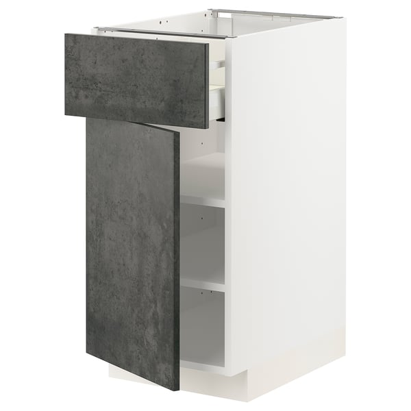 An open white METOD kitchen cabinet with dark grey kalhyttan fronts; comprises shelves and drawers.