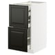 Modern METOD kitchen cabinet with black bodbyn drawers, sleek design, white frame. Pull-out drawers with smooth, self-close function.