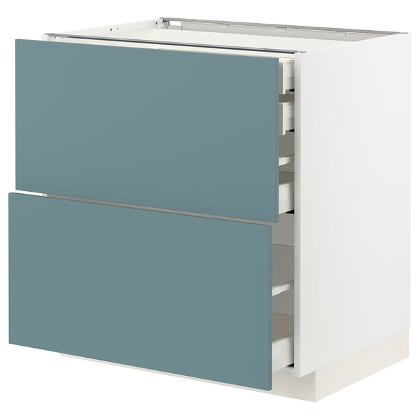 Modern kitchen cabinet, white and turquoise, multiple drawers.