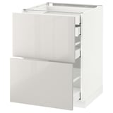 White METOD kitchen cabinet with glossy drawers and sleek modern design.