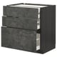 An open dark grey ikea METOD kitchen cabinet with three drawers, featuring a clever design and urban look.