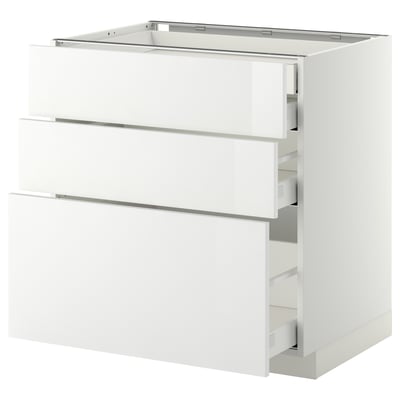 White glossy kitchen cabinet set with three drawers and a large drawer partially pulled out. Modern and sleek design.