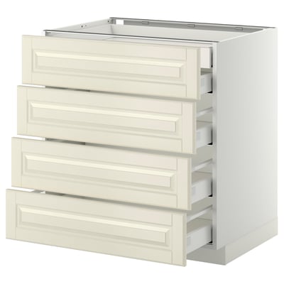 A white METOD kitchen unit with four cream-colored beveled drawers.