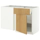 A METOD white and light wood kitchen cabinet with one door open, revealing an adjustable shelf inside.