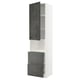 A tall white kitchen cabinet from the METOD system with dark grey concrete effect kalhyttan doors, featuring open compartments and drawers.