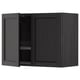 Black kitchen cabinet, modern design with one door open, made of wood, containing a dish drainer.