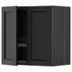 A black METOD kitchen wall cabinet with one door open, revealing adjustable shelves and a dish drainer inside.