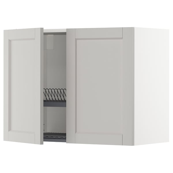 White kitchen wall cabinet, open door revealing shelf with wire dish drainer, angular modern design.