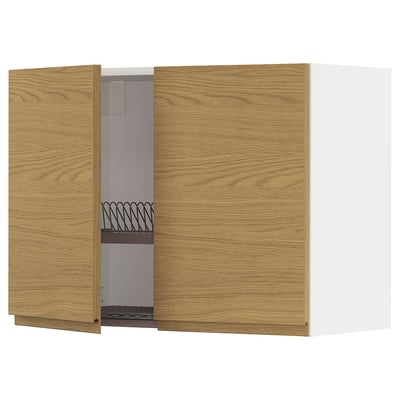 A wooden kitchen wall cabinet from the METOD system, featuring oak-colored doors with a minimalist design and integrated handles.